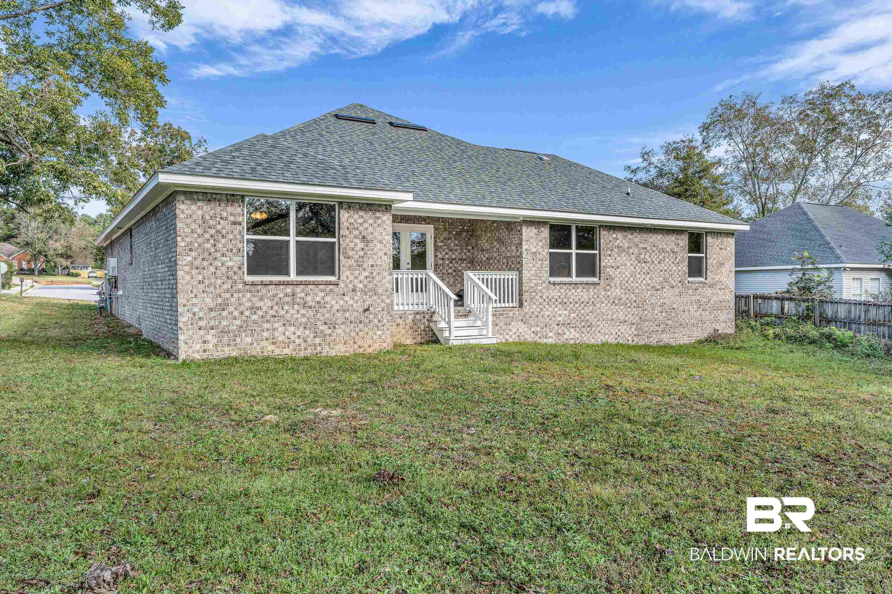 9206 Greenleaf Drive Daphne, AL 36527 - Photo 23 of 32 Back of house featuring brick siding and roof with shingles