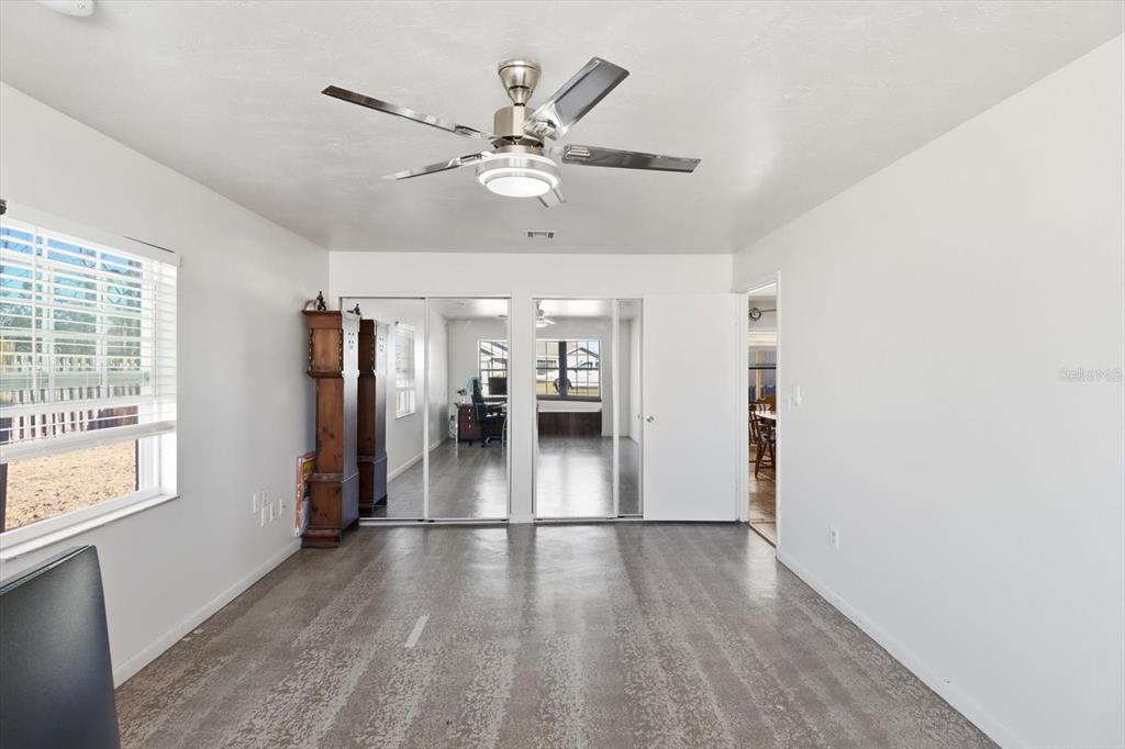 6940 Southeast 52nd Street Ocala, FL 34472 - Photo 17 of 45 a hallway with wooden floor chandelier and windows