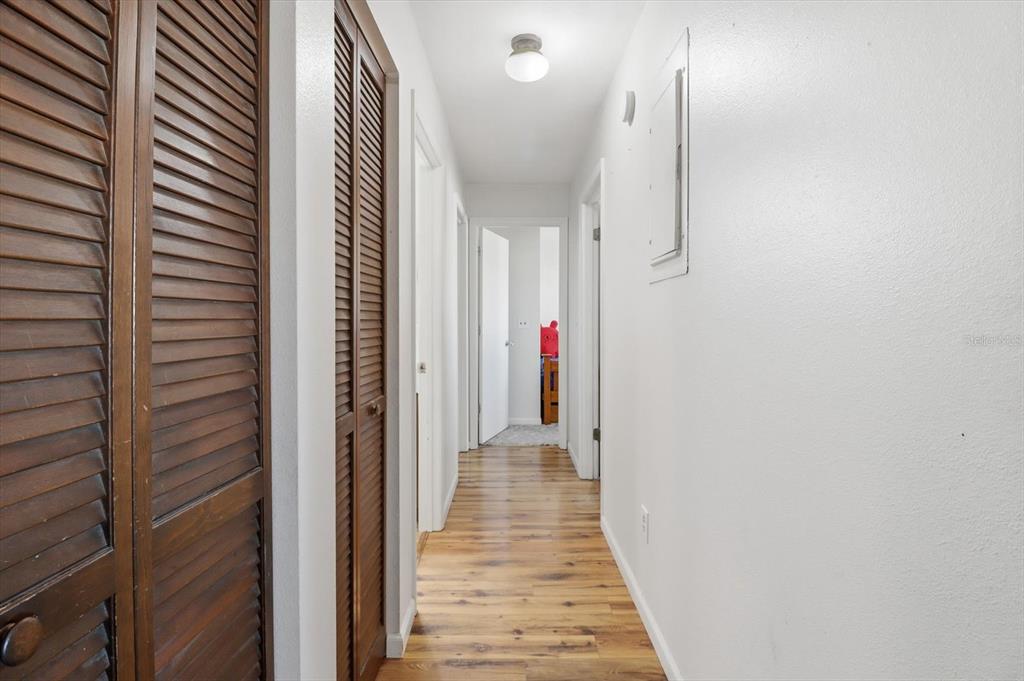 6940 Southeast 52nd Street Ocala, FL 34472 - Photo 18 of 45 a view of a hallway with wooden floor and staircase