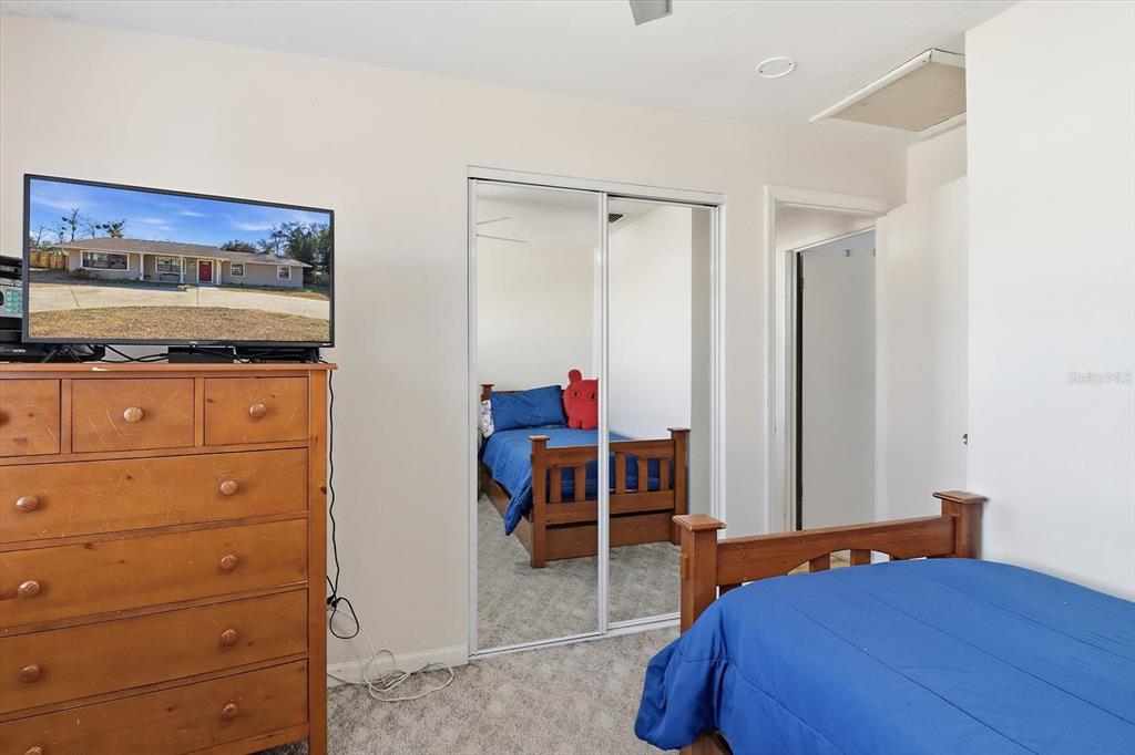 6940 Southeast 52nd Street Ocala, FL 34472 - Photo 24 of 45 a bedroom with a bed and a dresser in it