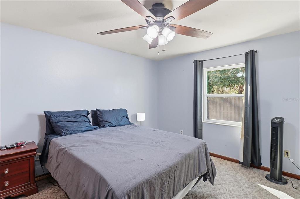 6940 Southeast 52nd Street Ocala, FL 34472 - Photo 25 of 45 a bedroom with a bed and a window