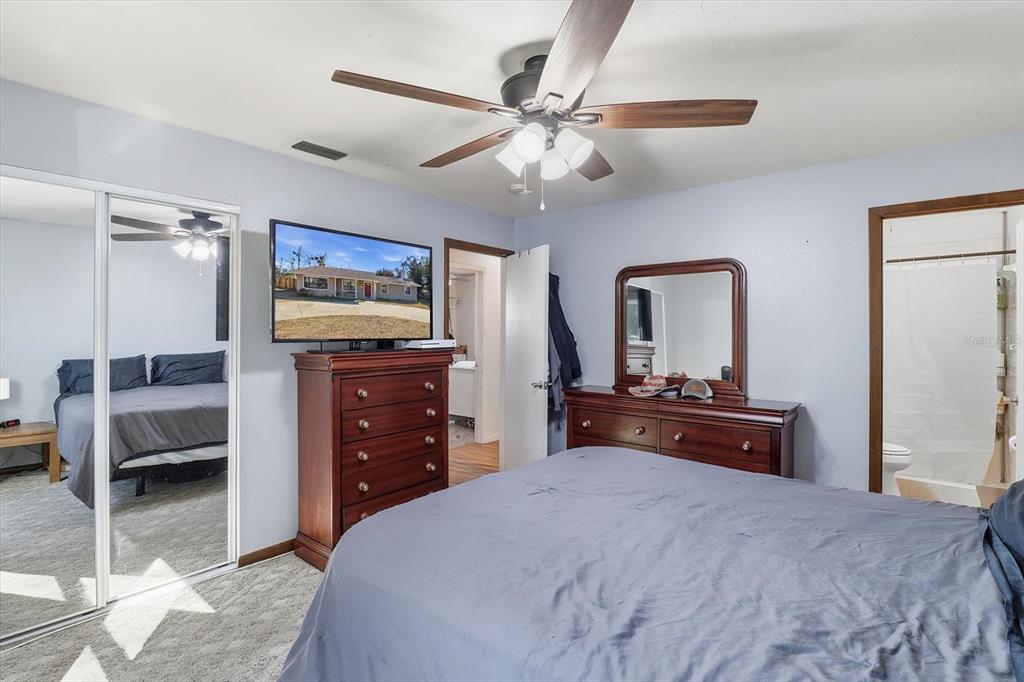 6940 Southeast 52nd Street Ocala, FL 34472 - Photo 27 of 45 a bedroom with a bed and a dresser in it