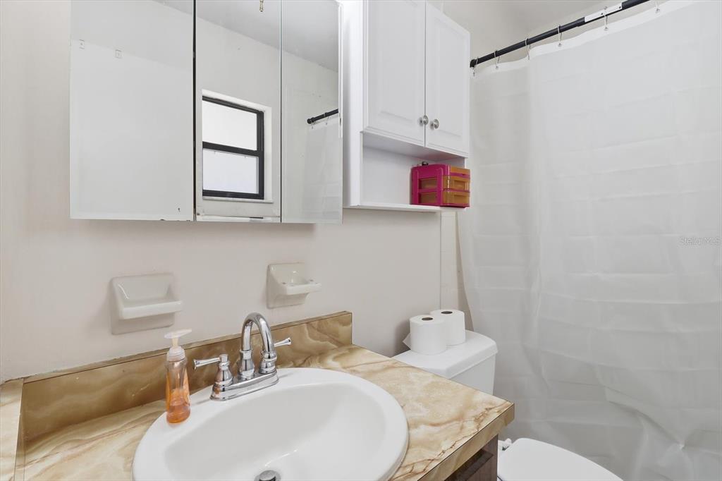 6940 Southeast 52nd Street Ocala, FL 34472 - Photo 28 of 45 a bathroom with a sink toilet and mirror