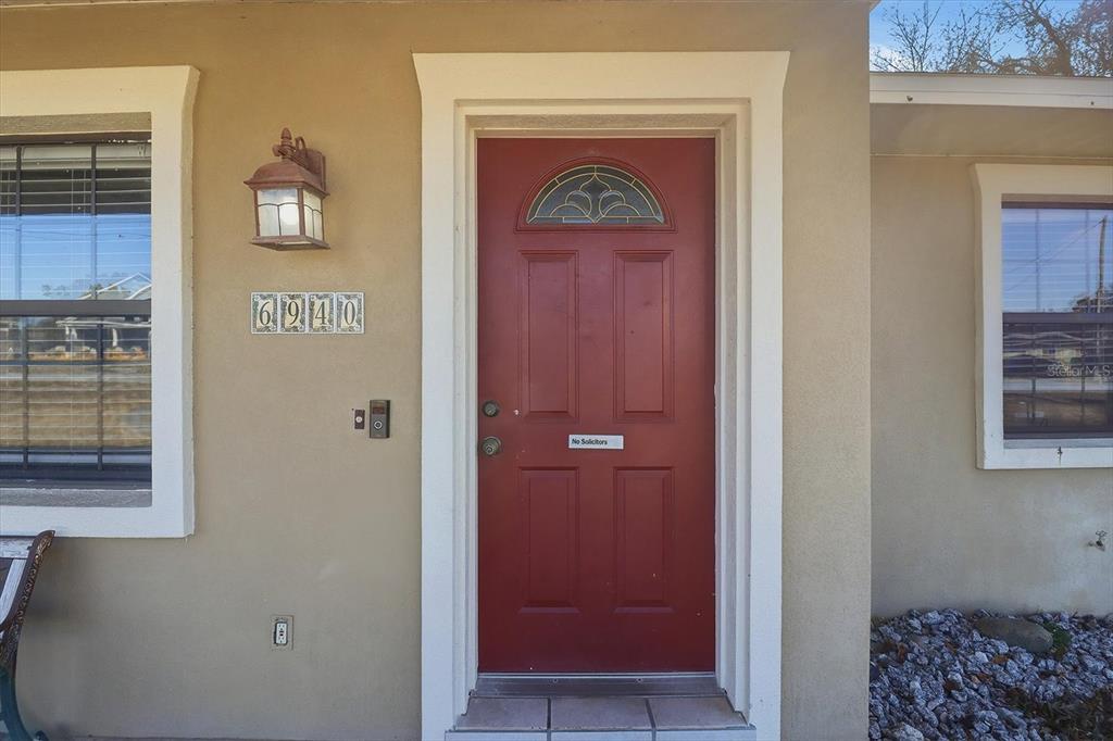 6940 Southeast 52nd Street Ocala, FL 34472 - Photo 5 of 45 a front view of a house with entryway