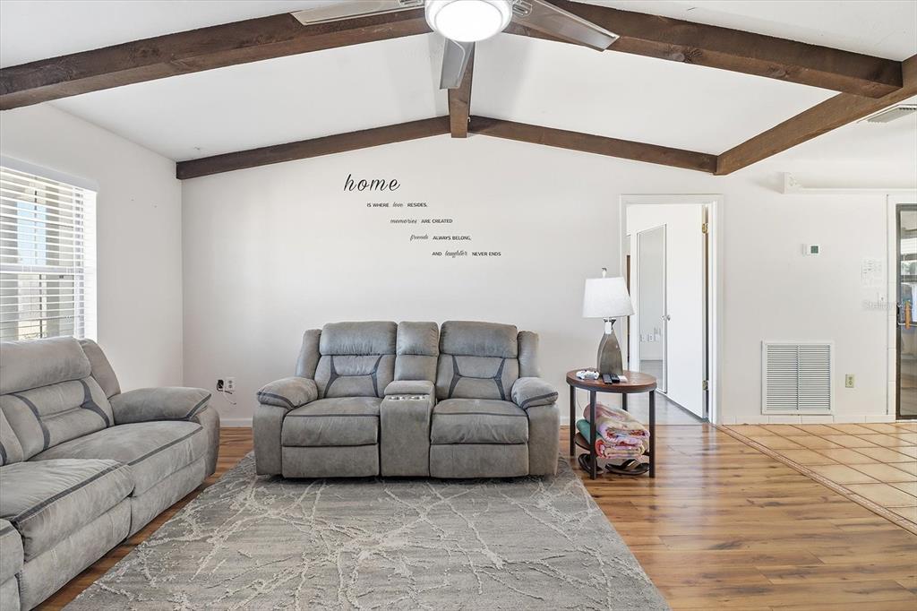 6940 Southeast 52nd Street Ocala, FL 34472 - Photo 6 of 45 a living room with furniture and a lamp