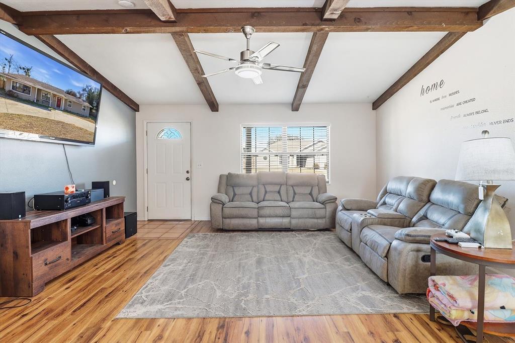 6940 Southeast 52nd Street Ocala, FL 34472 - Photo 7 of 45 a living room with furniture and a wooden floor