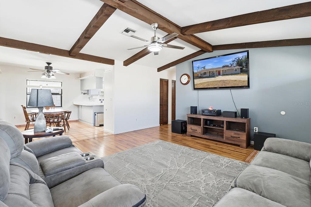 6940 Southeast 52nd Street Ocala, FL 34472 - Photo 8 of 45 a living room with furniture and a flat screen tv
