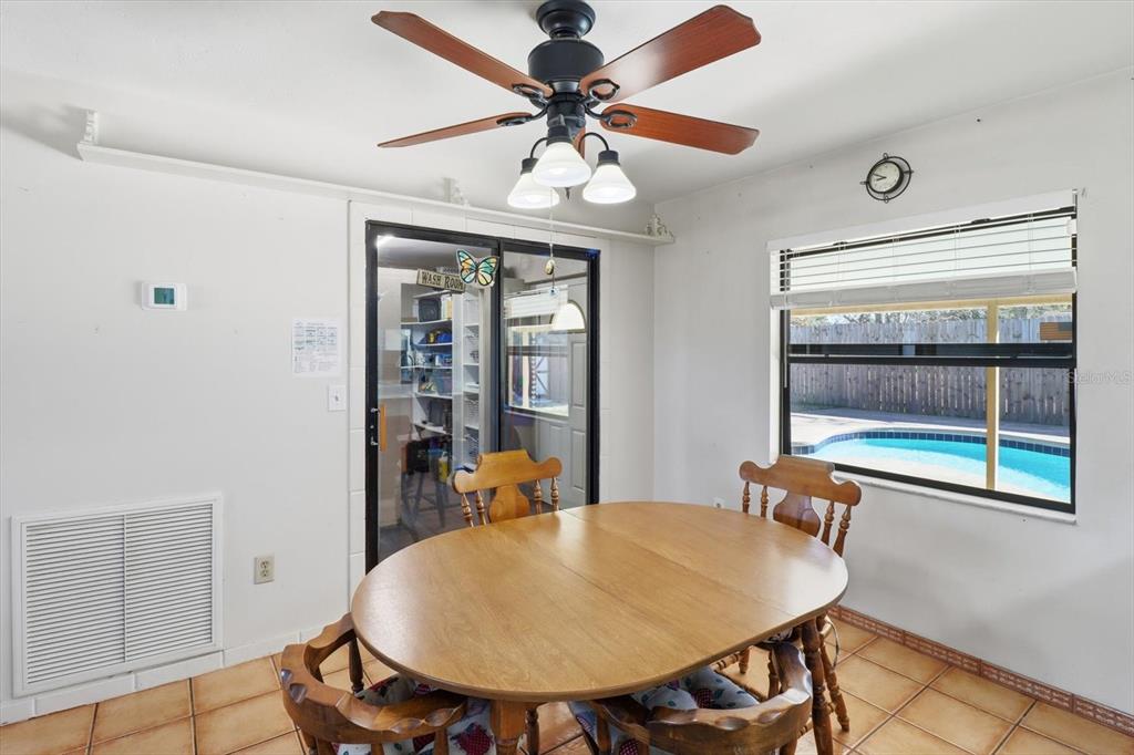 6940 Southeast 52nd Street Ocala, FL 34472 - Photo 10 of 45 a view of a dining room with furniture and wooden floor