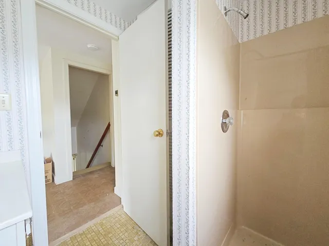 a view of a hallway with a room and stairs