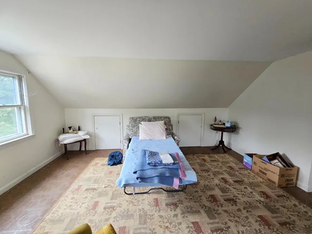a room with a bed and window