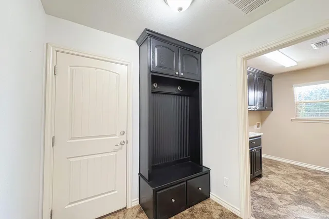 a view of a hallway to rooms and stairs