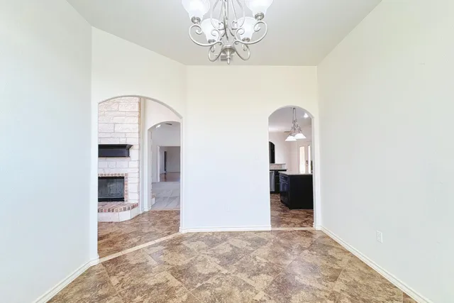 a view of a big room with chandelier and entryway