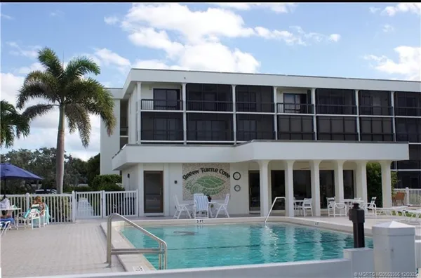 a front view of house with a garden and patio