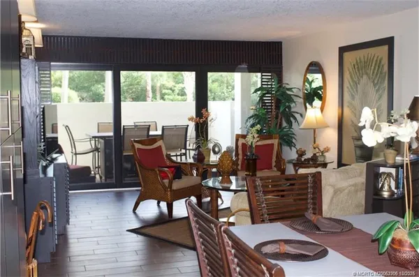 a living room with furniture and a floor to ceiling window