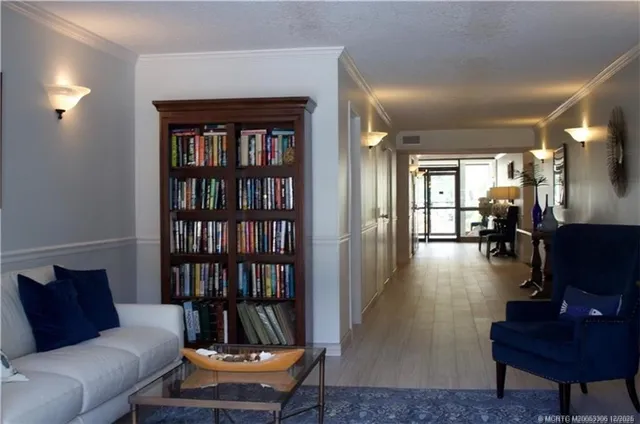 a living room with furniture and a book shelf