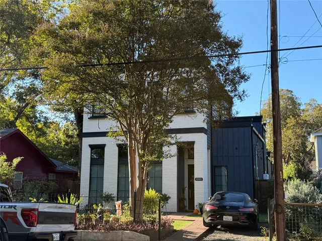 a couple of cars parked in front of a house