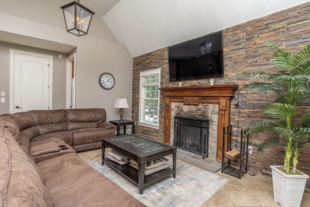 19 Round Farm Road Rehoboth, MA 02769 - Photo 17 of 42 a living room with furniture a flat screen tv and a fireplace