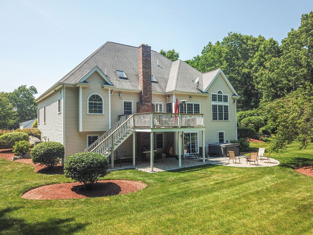 19 Round Farm Road Rehoboth, MA 02769 - Photo 3 of 42 a front view of a house with a yard table and chairs