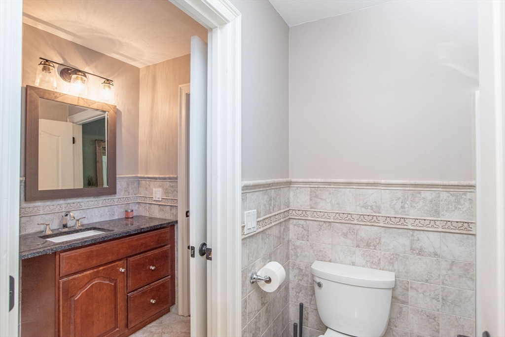 19 Round Farm Road Rehoboth, MA 02769 - Photo 33 of 42 a bathroom with a granite countertop sink a toilet and a mirror