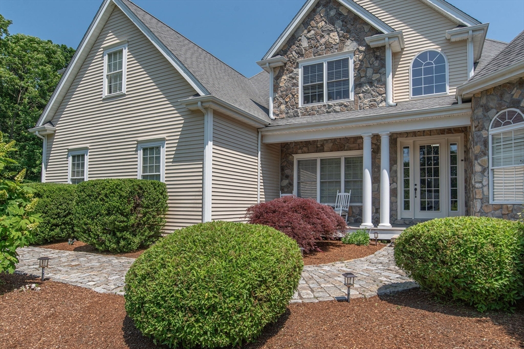 19 Round Farm Road Rehoboth, MA 02769 - Photo 4 of 42 a front view of a house with a garden