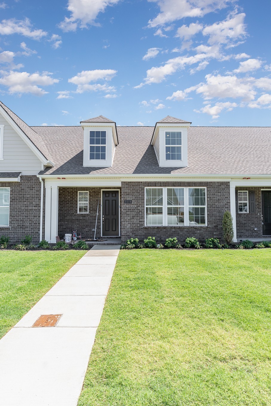 1079 Wrights Mill Road, Unit H8 Spring Hill, TN 37174 - Photo 52 of 64 a front view of a house with a garden