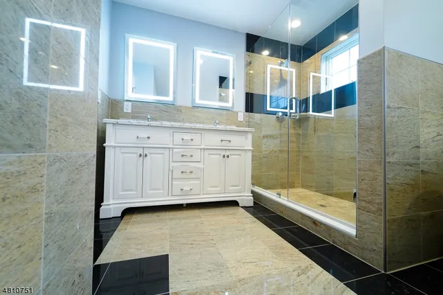 a bathroom with a granite countertop sink mirror and bathtub