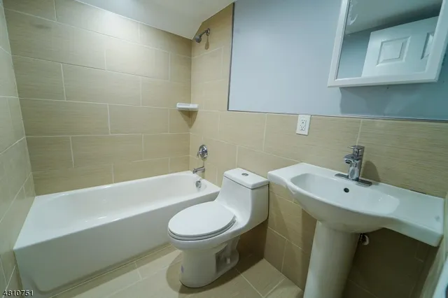 a bathroom with a sink a toilet and bathtub