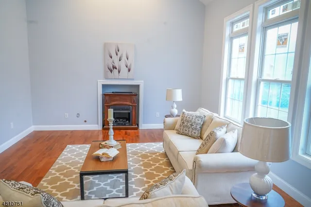 a living room with furniture and a fireplace