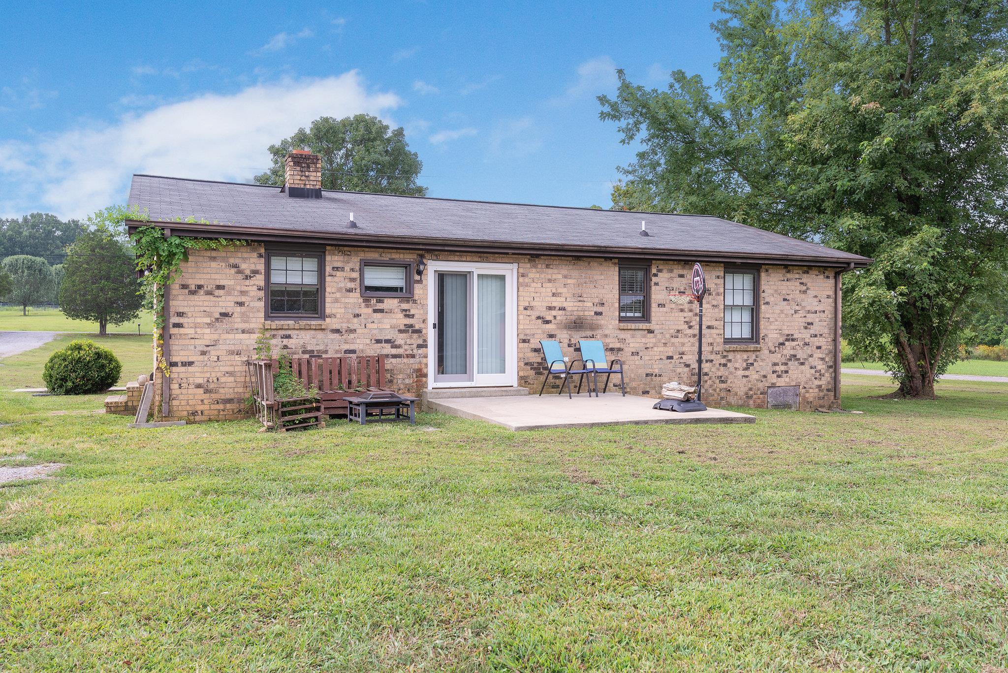 1011 Hamilton Chambers Road Lebanon, TN 37087 - Photo 11 of 14 a view of a patio with table and chairs and potted plants