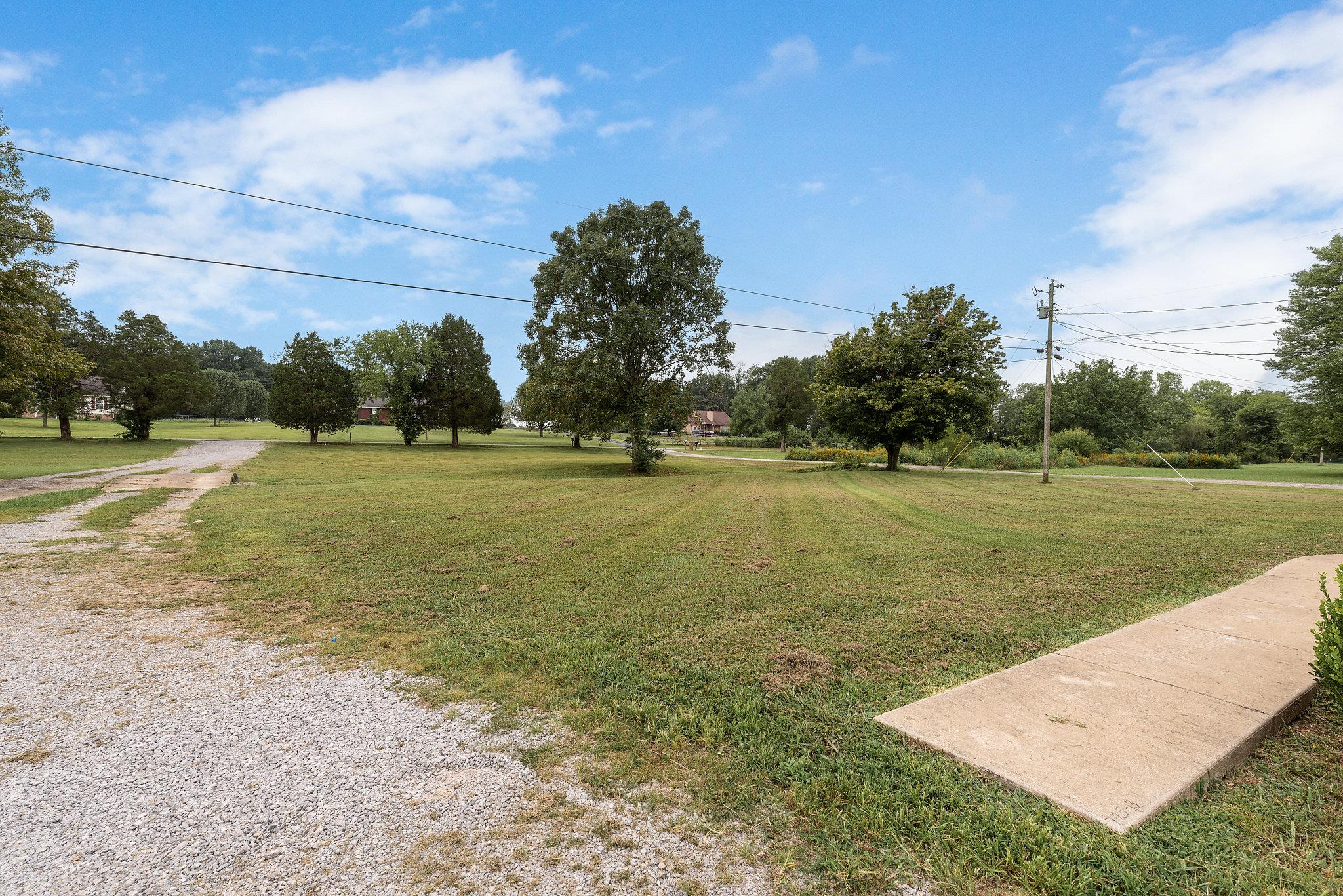 1011 Hamilton Chambers Road Lebanon, TN 37087 - Photo 13 of 14 a view of a field with grass and a palm tree