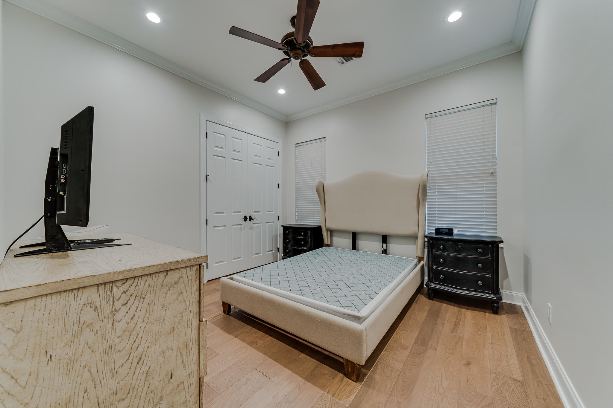 2922 Sand Pine Road Miramar Beach, FL 32550 - Photo 34 of 36 a bedroom with a bed and a flat tv screen on a dresser