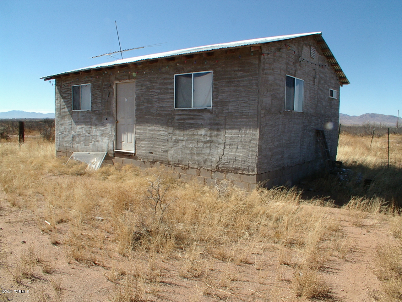 6065 Round Up Road Willcox, AZ 85643 - Photo 1 of 14 a brick house with a large window