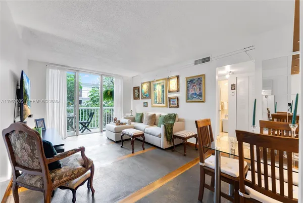 a living room with furniture and a floor to ceiling window