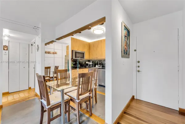 a dining room with furniture and wooden floor