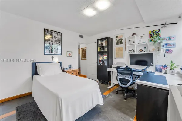 a bedroom with a bed and a desk