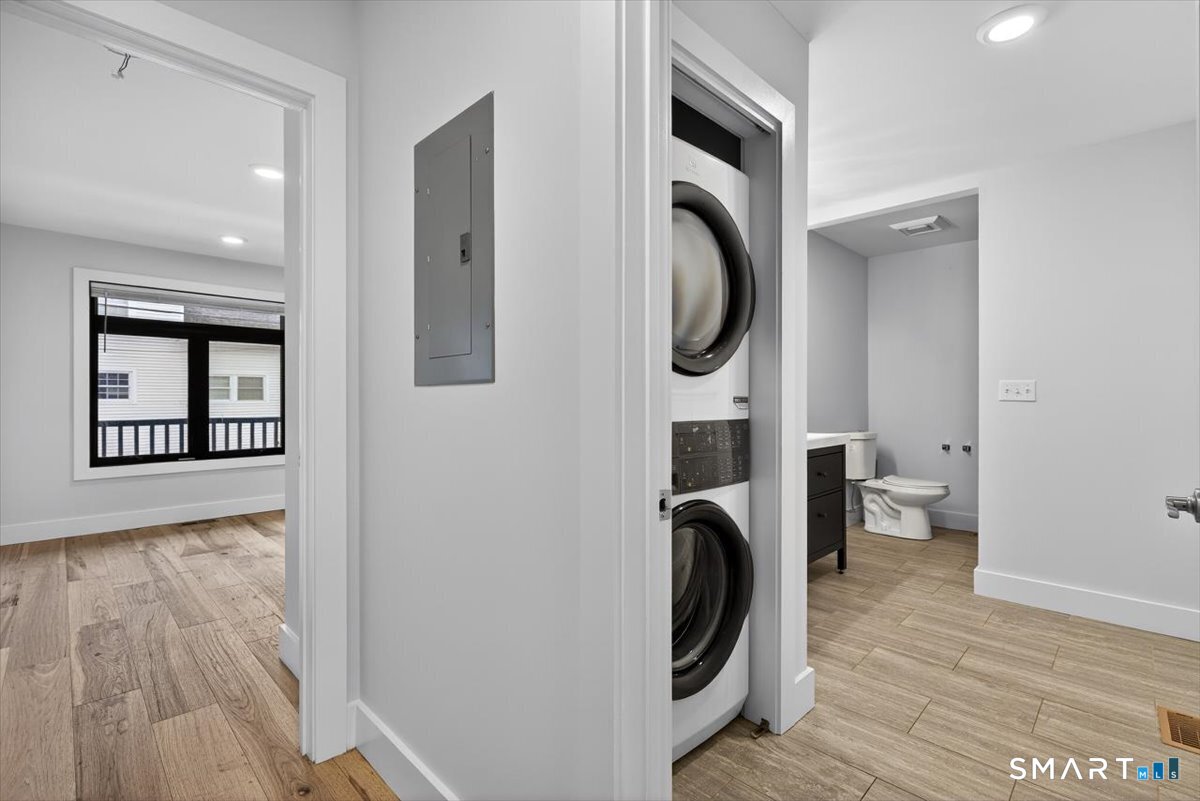 32 1/2 Village Road, Unit 1 Milford, CT 06460 - Photo 16 of 31 a view of a storage & utility room with wooden floor