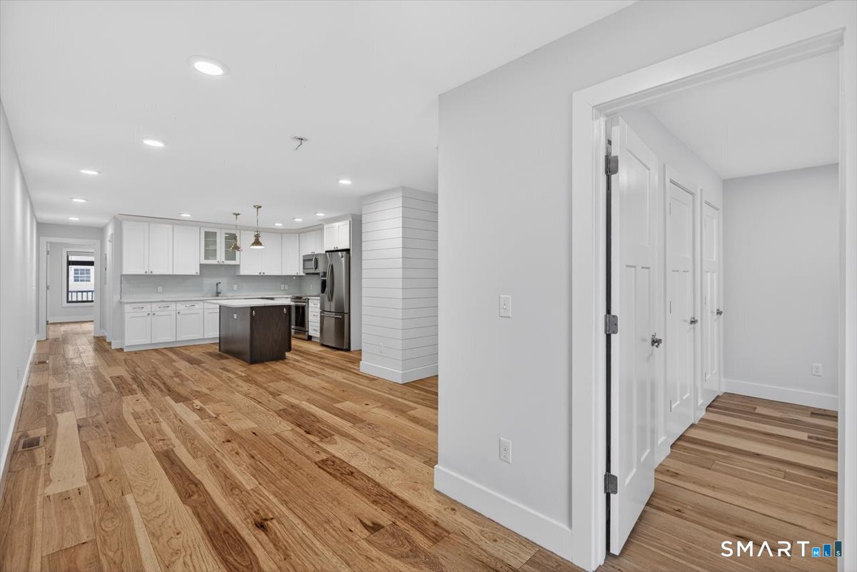 32 1/2 Village Road, Unit 1 Milford, CT 06460 - Photo 6 of 31 a view of kitchen and wooden floor