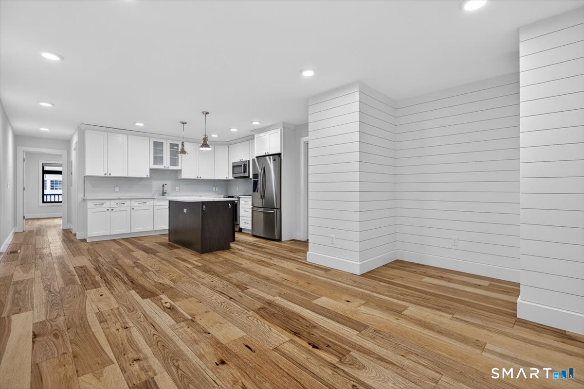 32 1/2 Village Road, Unit 1 Milford, CT 06460 - Photo 7 of 31 a view of kitchen with wooden floor