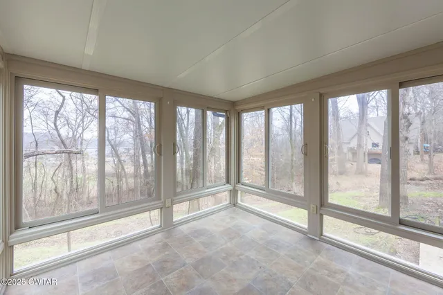 a view of an empty room with windows