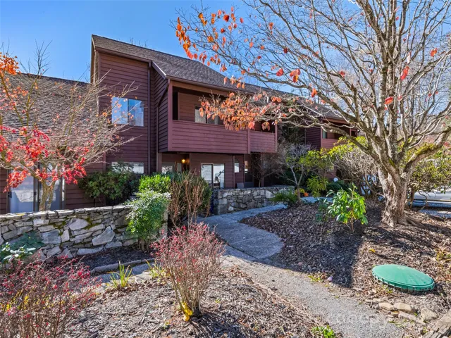 a front view of a house with yard and outdoor seating
