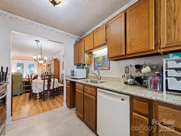 a kitchen with stainless steel appliances granite countertop sink stove and cabinets