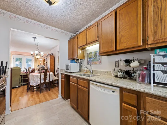 a kitchen with stainless steel appliances granite countertop sink stove and cabinets