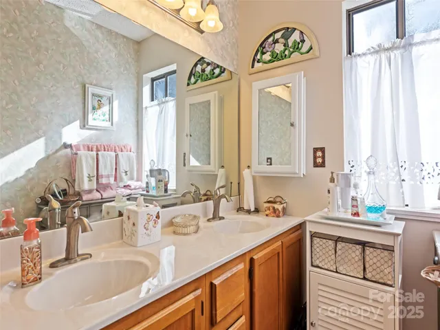 a bathroom with a sink double vanity and a mirror
