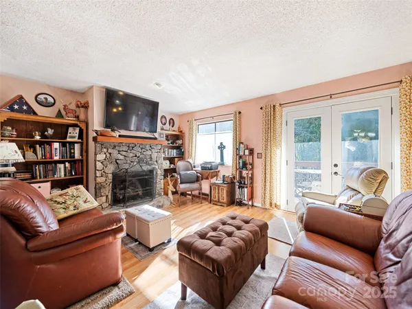 a living room with furniture a fireplace and a flat screen tv