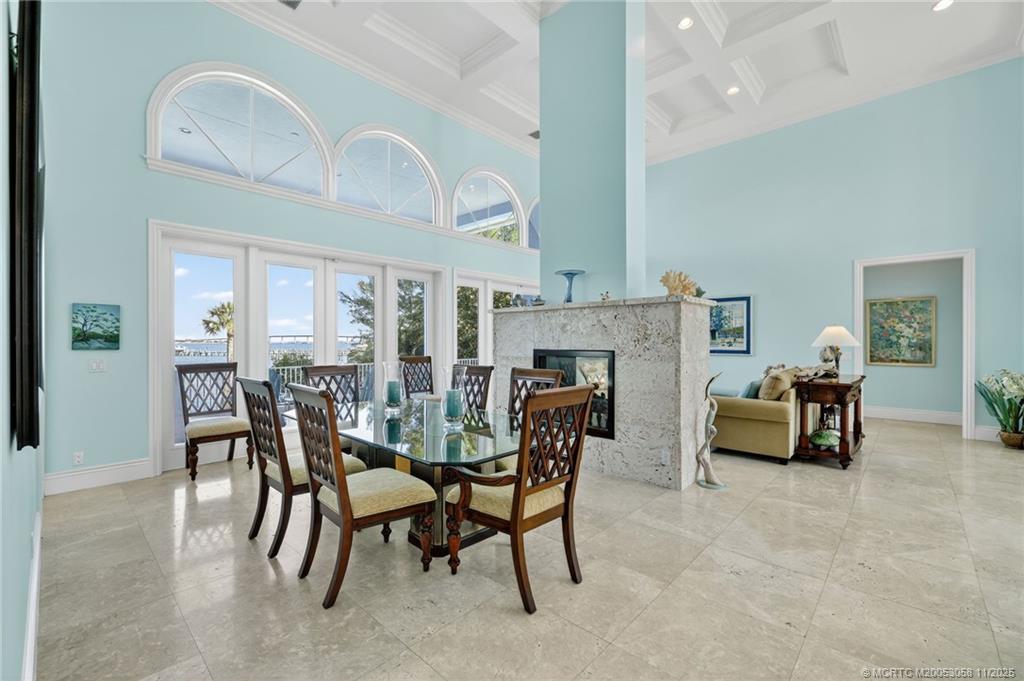 70 North Sewalls Point Road Stuart, FL 34996 - Photo 16 of 72 a dining room with furniture and a fireplace