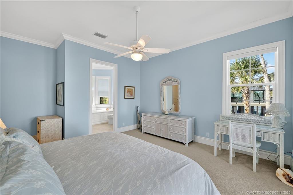 70 North Sewalls Point Road Stuart, FL 34996 - Photo 50 of 72 a bedroom with a bed chandelier and a window