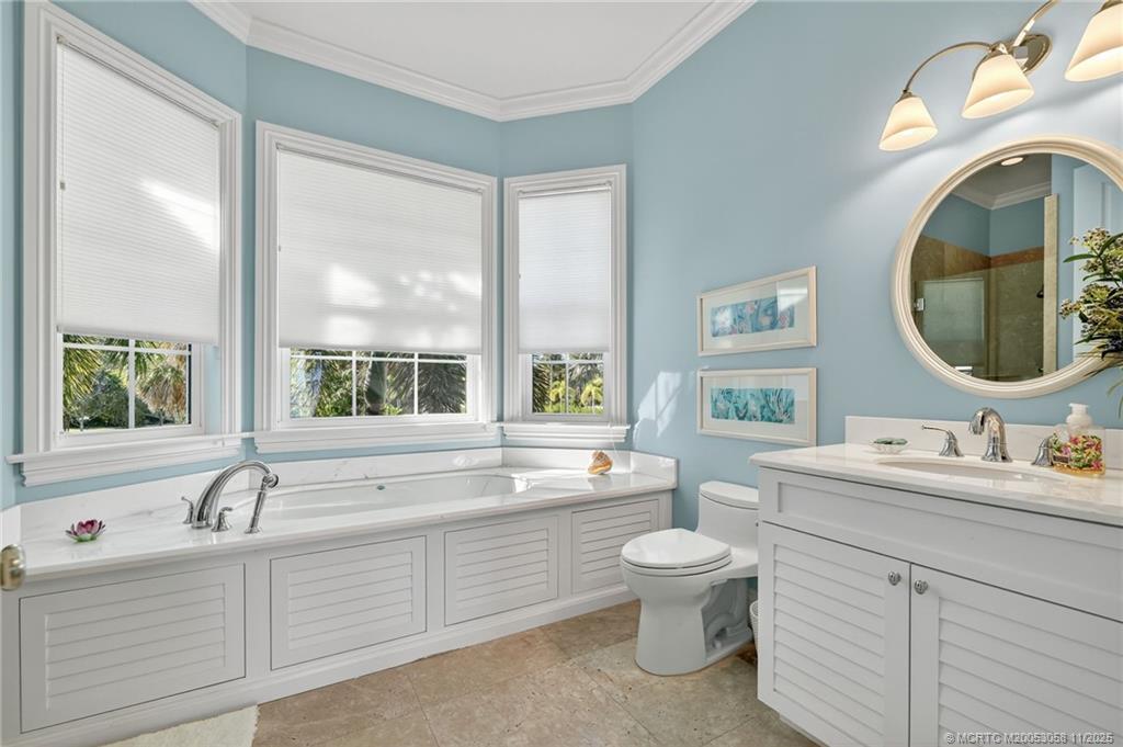70 North Sewalls Point Road Stuart, FL 34996 - Photo 51 of 72 a bathroom with a double vanity sink toilet mirror and window