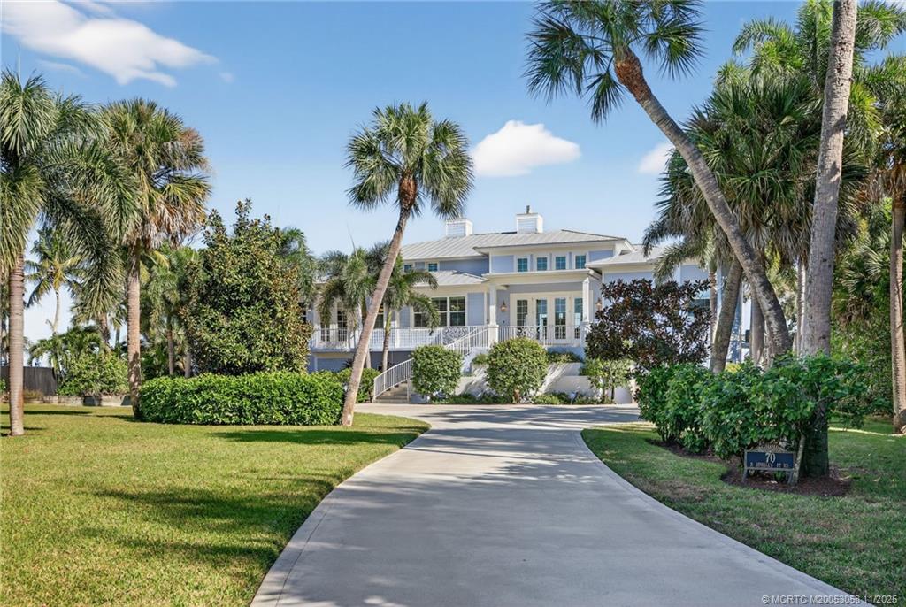 70 North Sewalls Point Road Stuart, FL 34996 - Photo 8 of 72 a front view of a house with a garden and a yard