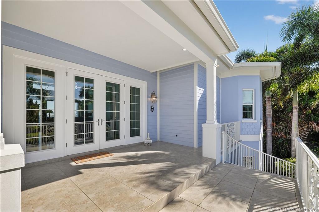 70 North Sewalls Point Road Stuart, FL 34996 - Photo 10 of 72 a front view of a house with a large window and potted plants