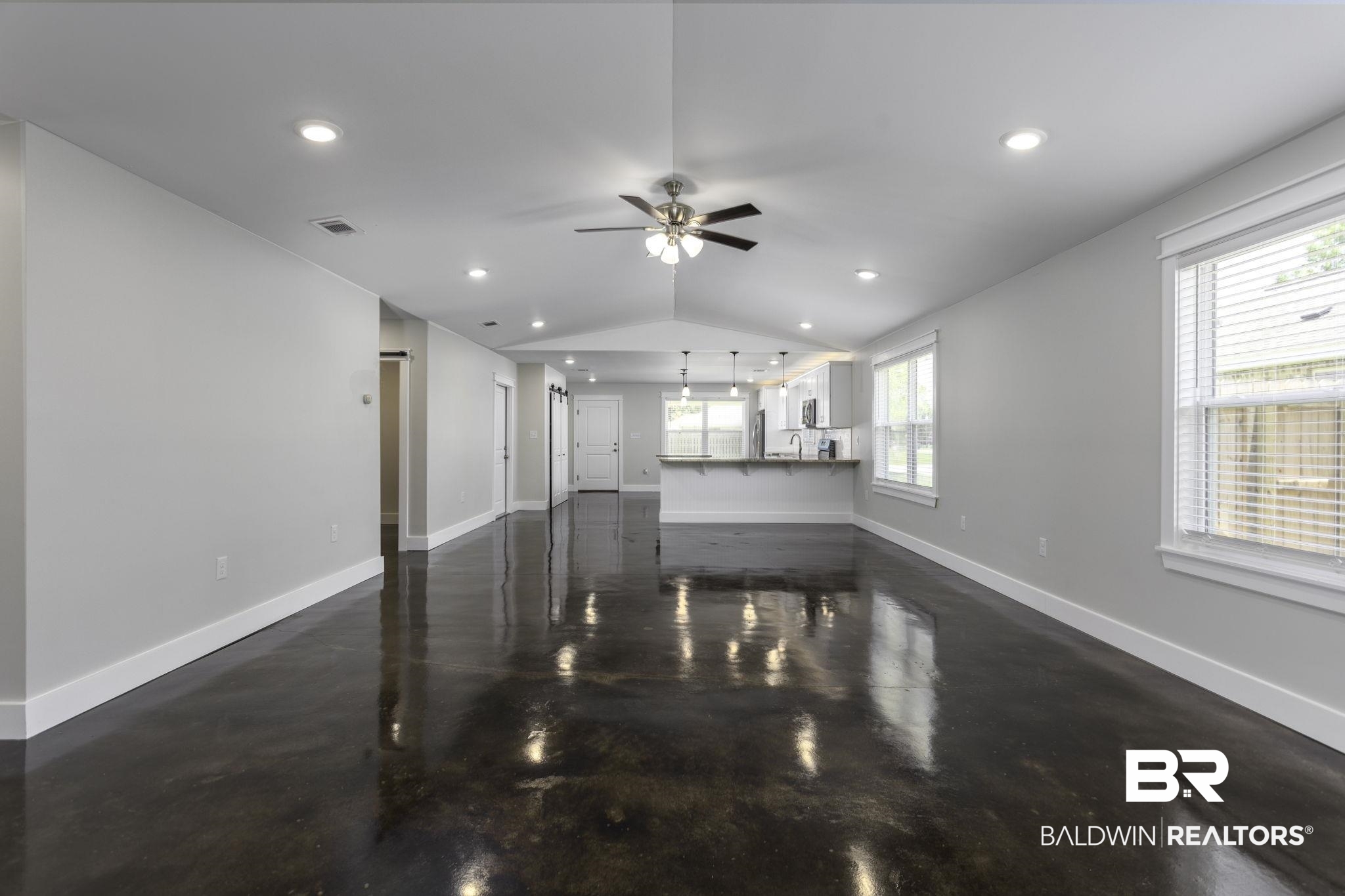 17126 Sugar Loop Foley, AL 36535 - Photo 5 of 28 Living area with ceiling fan, recessed lighting, vaulted ceiling, and concrete flooring